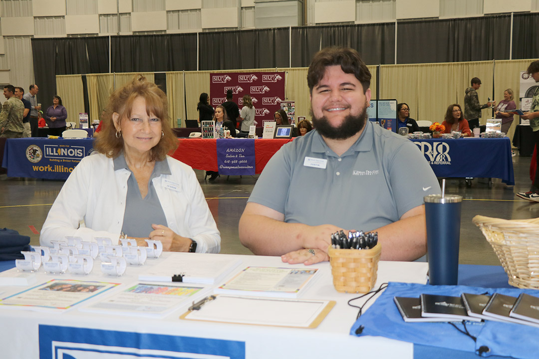 Youth Program Coordinator Jo Dene Kern and Career Specialist Justin Dodd welcome students to the ManTraCon table.