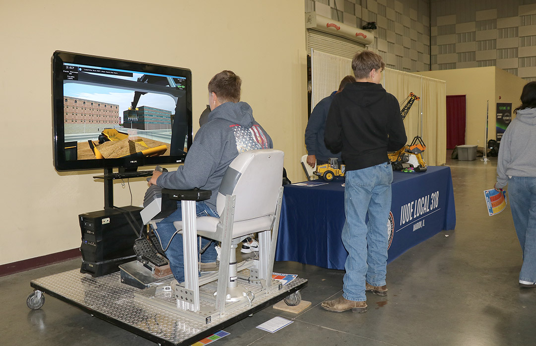 Students were able to experience simulated training software at the IUOE Local #318 booth.