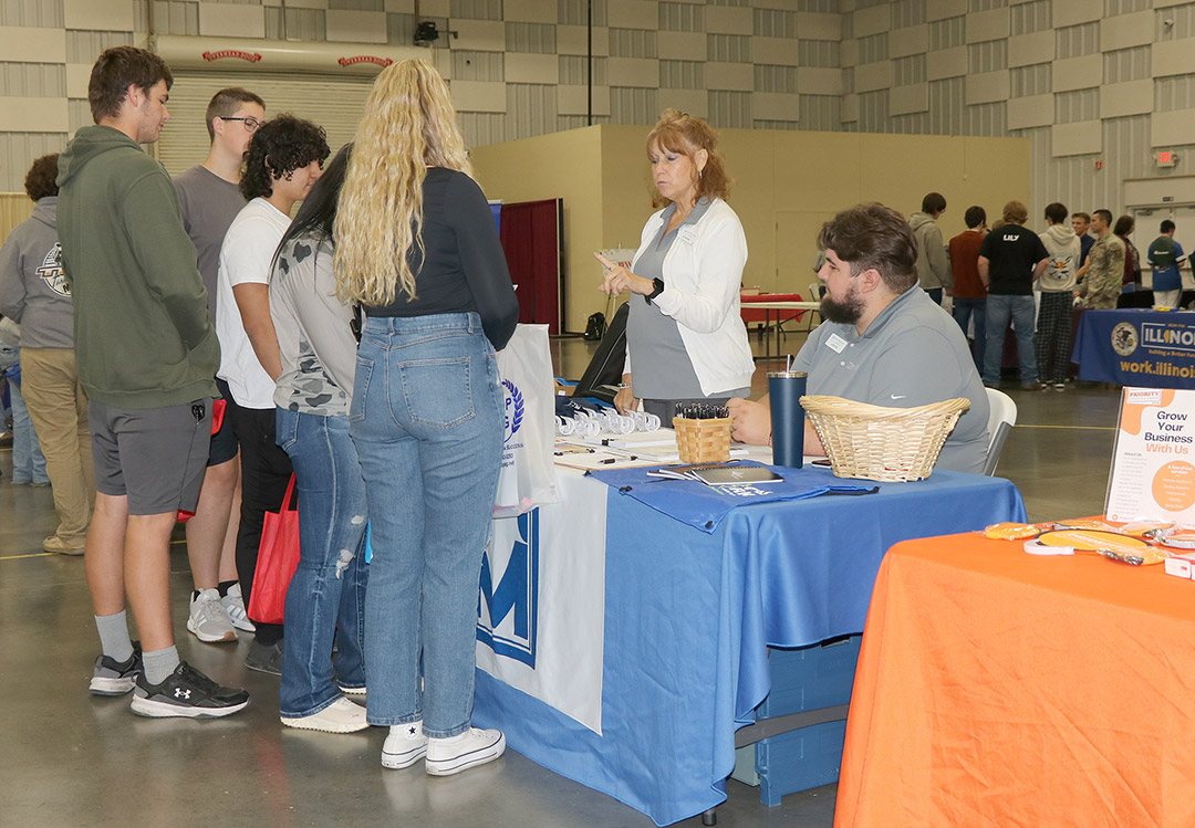 Youth Program Coordinator Jo Dene Kern and Career Specialist Justin Dodd speak with students about Man-Tra-Con services.