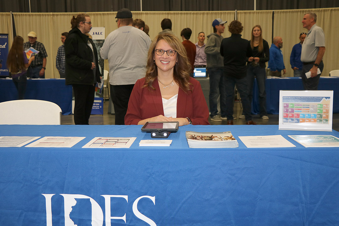 Heather Clarida welcomes students to the IDES booth.