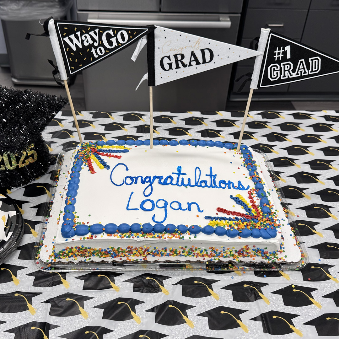 Man-Tra-Con honors Logan with a graduation cake. 