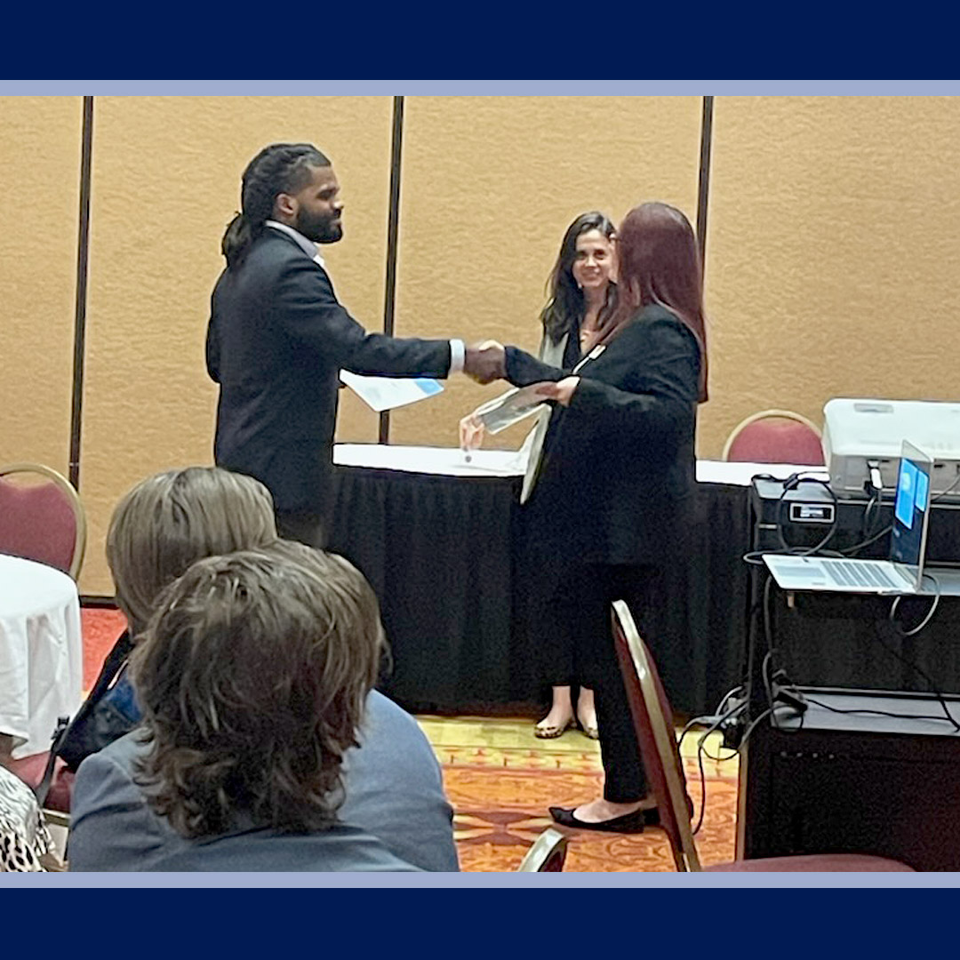 Abby receives her badge for completing the TCM course.