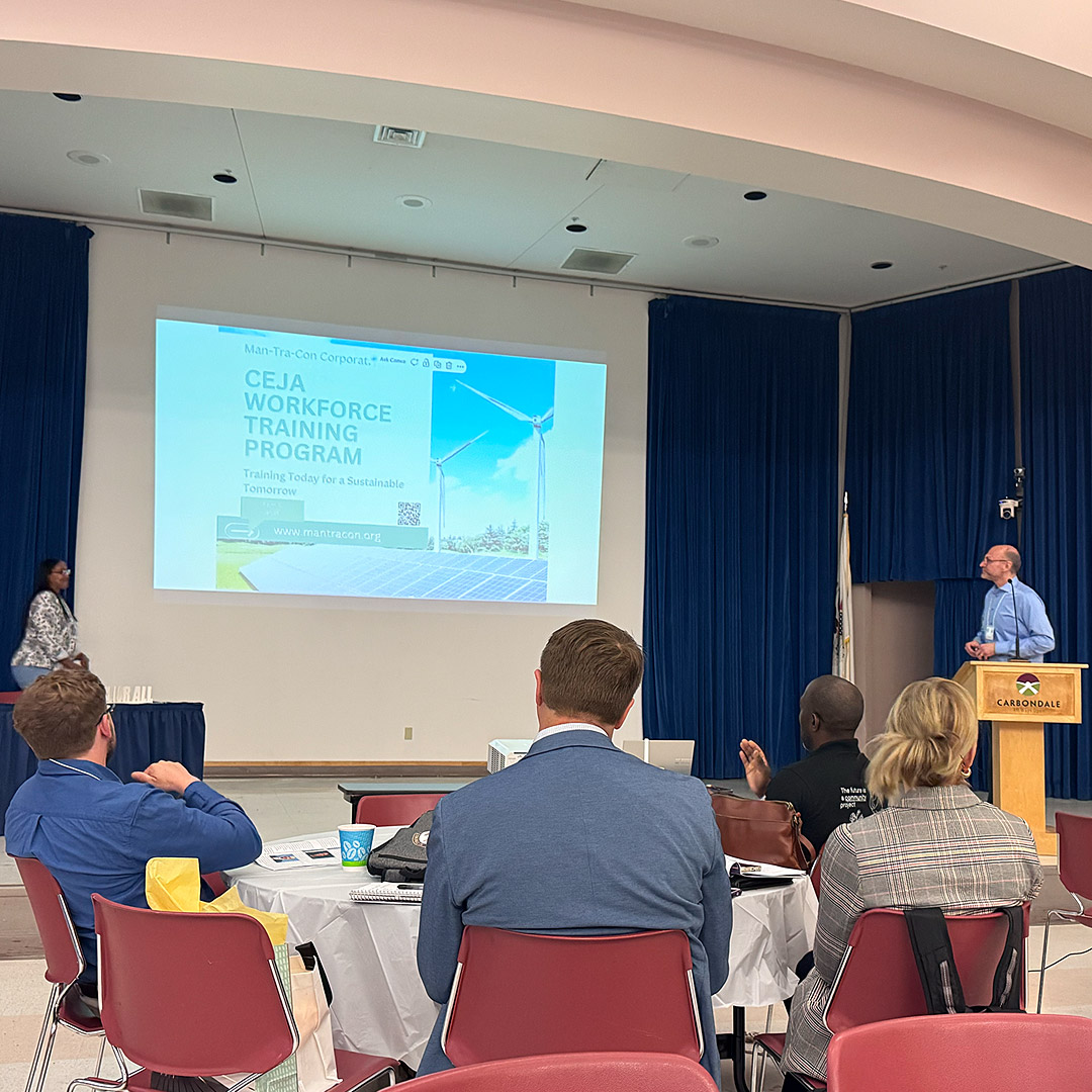 Man-Tra-Con CEJA Program Director Greg Bouhl (right) talks about the CEJA clean energy workforce training program.