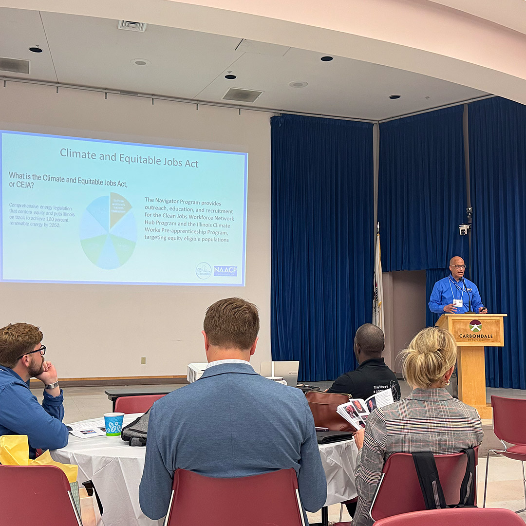NAACP CEJA Program Director Kevin Clark (right) explains details of the CEJA clean energy workforce training program.