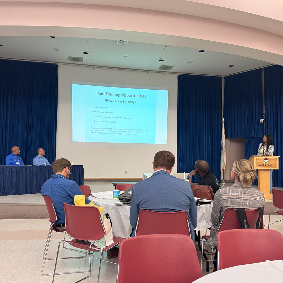 Man-Tra-Con CEJA Training & Outreach Manager Marcella Woodson (right) talks about career opportunities for participants in the CEJA clean energy workforce training program.