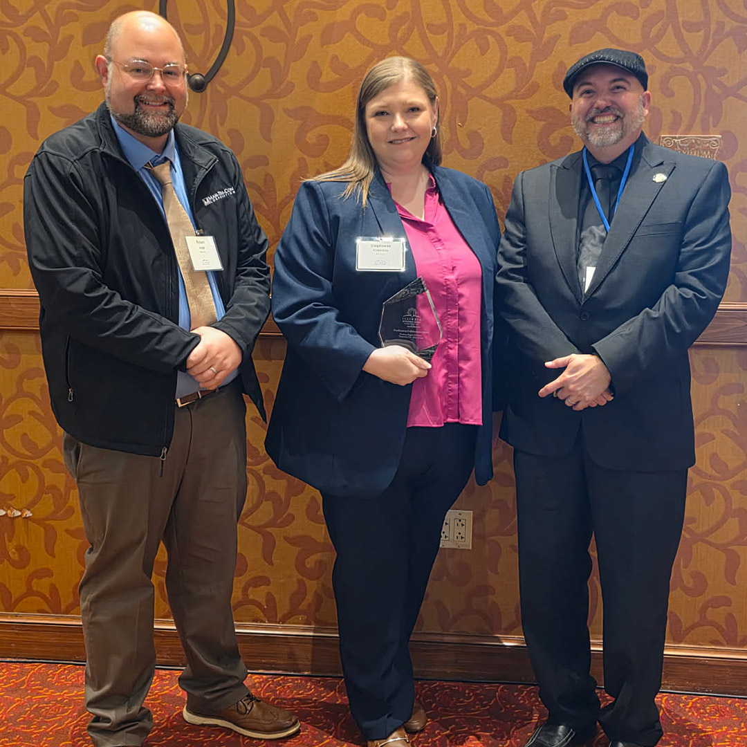 Man-Tra-Con receives an “Excellence in Collaboration Award” at the Illinois Workforce Summit in Peoria. Left to right: Man-Tra-Con Training & Reintegration Career Specialist Robert Angle, CEO Stephanie Robinson, and Freddie Buckingham from the Illinois Department of Employment Security - IDES.