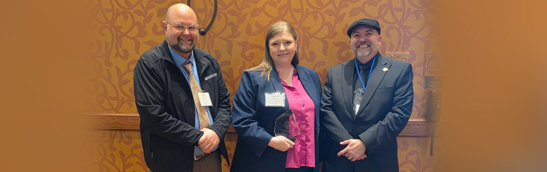 Man-Tra-Con receives an “Excellence in Collaboration Award” at the Illinois Workforce Summit in Peoria. Left to right: Man-Tra-Con Training & Reintegration Career Specialist Robert Angle, CEO Stephanie Robinson, and Freddie Buckingham from the IDES.