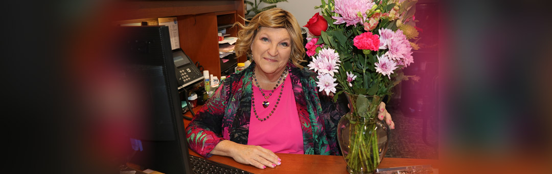Tammy Kirk receives flowers for Professional Admin Day.